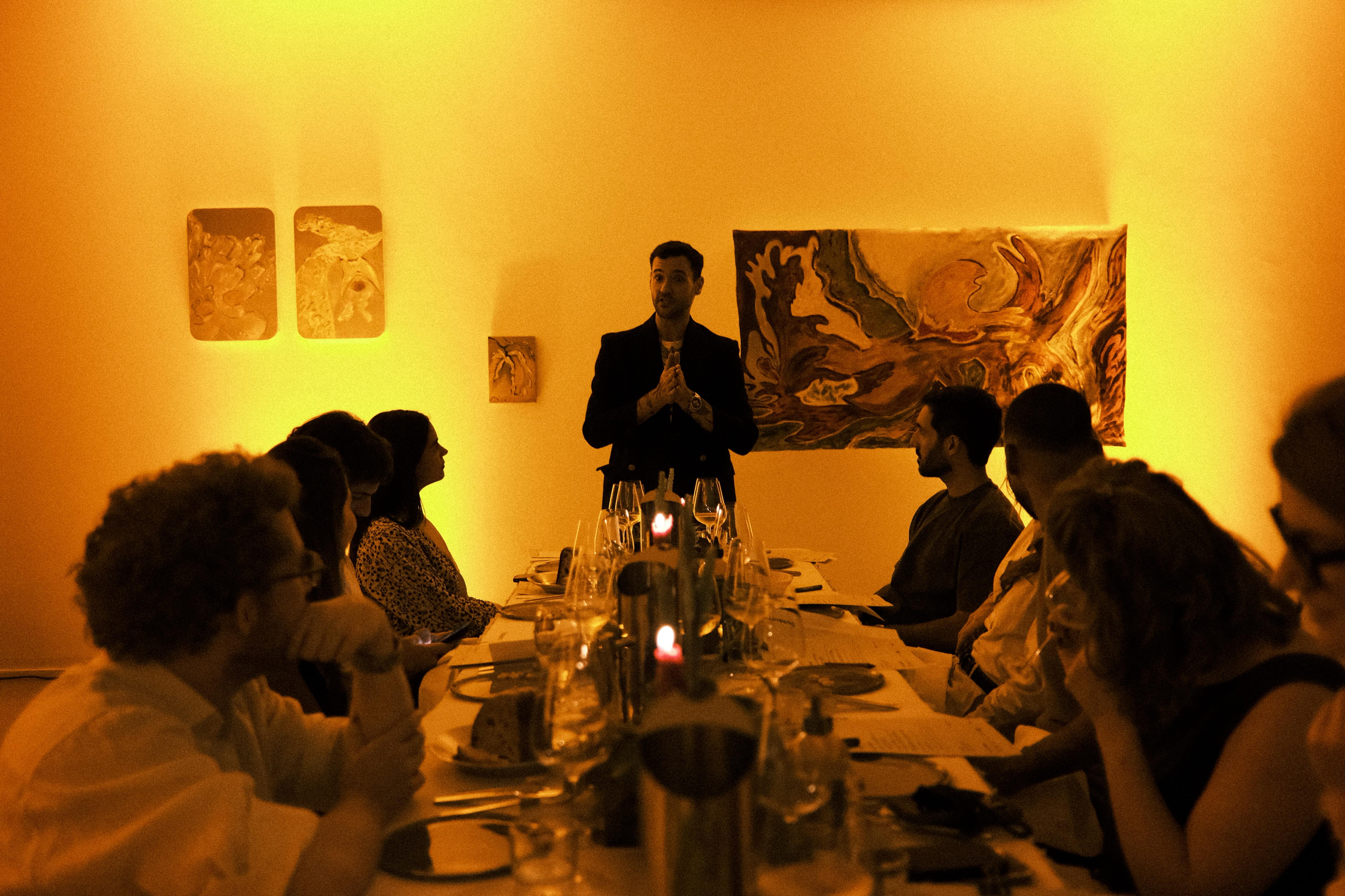 Chef Pedro Forato addressing guests at the table