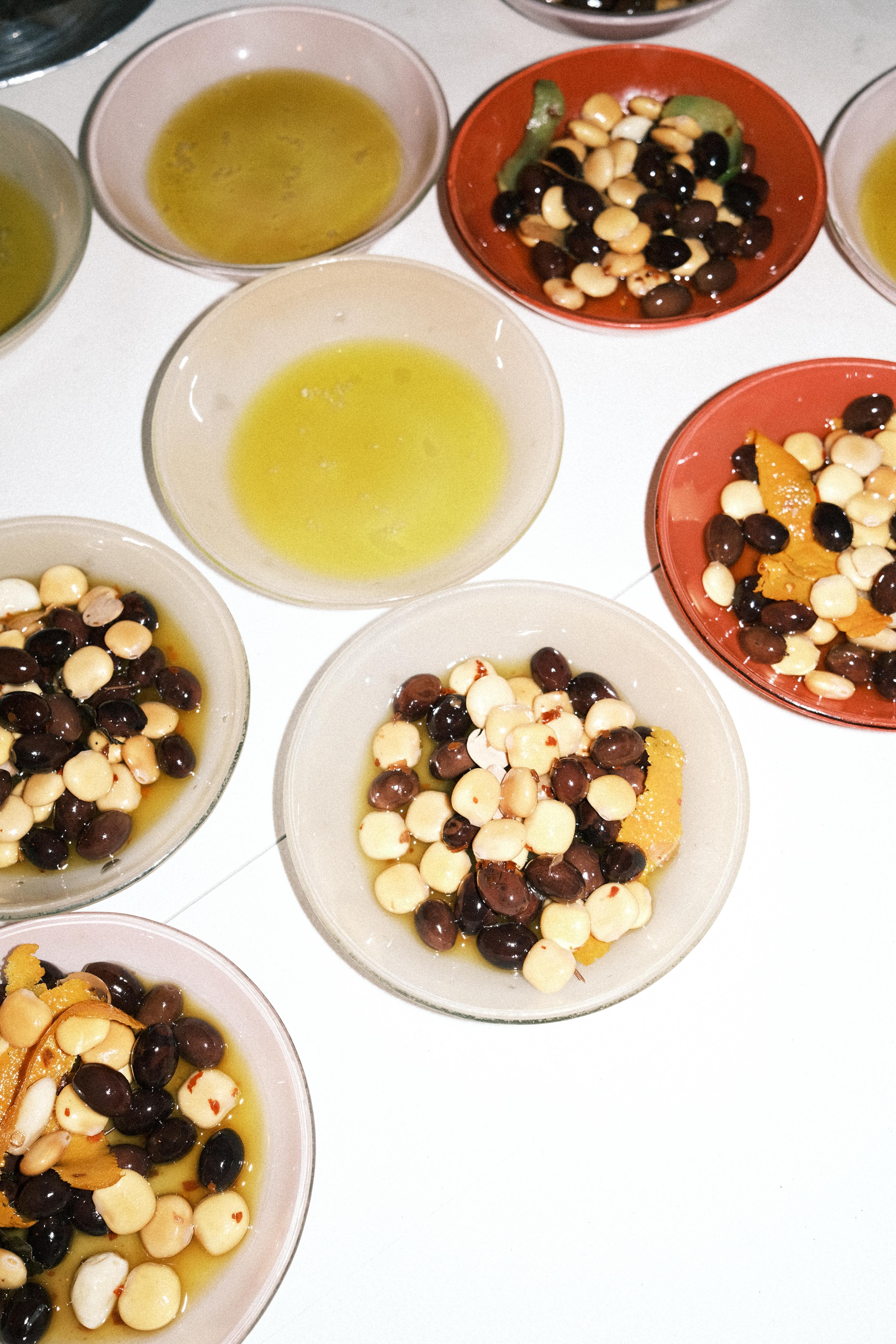 Olive and citrus bowls plated overhead
